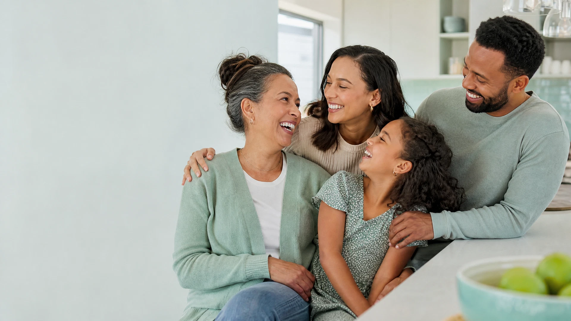 A multigenerational family laughing together in a bright home